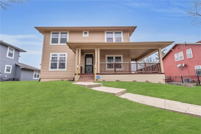 5312 Woodland Ave, Kansas City, MO 64110 - view of front facade featuring covered porch and a front yard