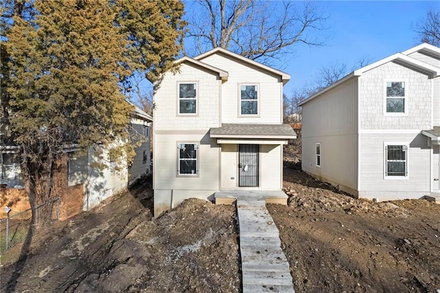 traditional home with a shingled roof