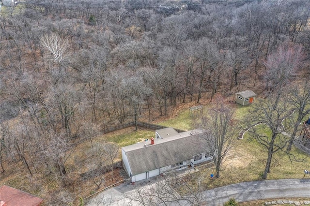 birds eye view of property with a view of trees