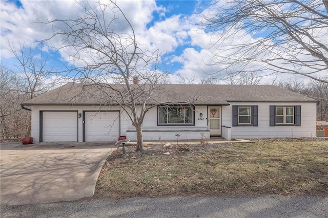 ranch-style home featuring a garage, concrete driveway, and a shingled roof