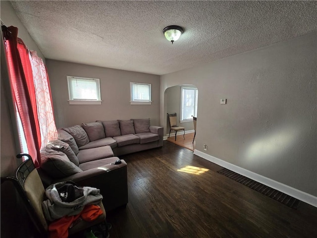 living room with hardwood / wood-style flooring and a textured ceiling