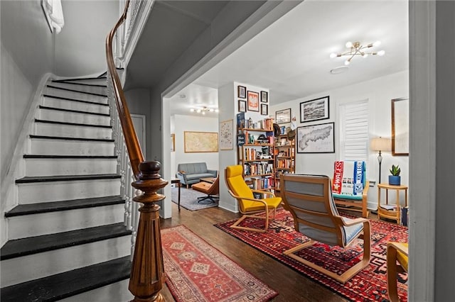 sitting room with stairway, baseboards, and wood finished floors