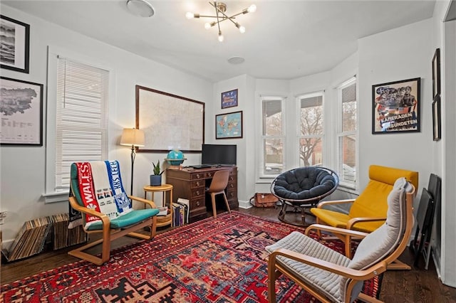 living area with a notable chandelier and wood finished floors