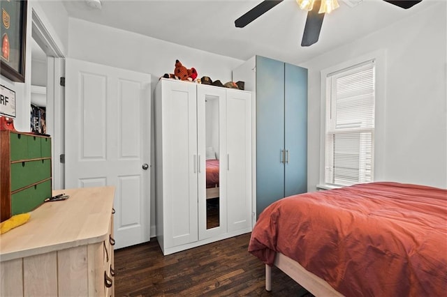 bedroom with ceiling fan and dark wood finished floors