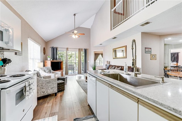 kitchen with sink, white appliances, ceiling fan, light hardwood / wood-style floors, and white cabinets