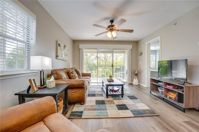 living room with ceiling fan and light hardwood / wood-style flooring