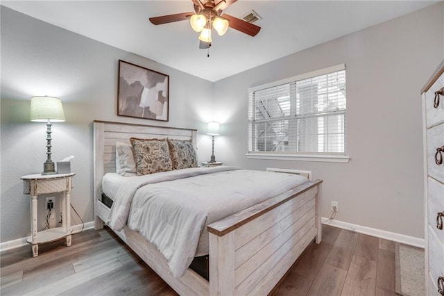 bedroom with hardwood / wood-style floors and ceiling fan