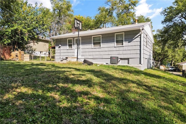 back of property featuring a yard and cooling unit