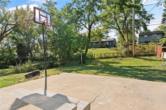 view of basketball court with a lawn