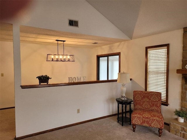 sitting room with lofted ceiling and carpet floors