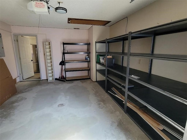 garage featuring a garage door opener and electric panel