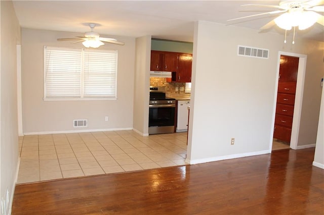 kitchen with electric range, visible vents, light countertops, and a ceiling fan