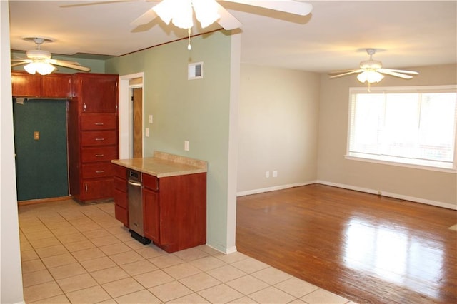 kitchen featuring ceiling fan, visible vents, light countertops, and dark brown cabinets