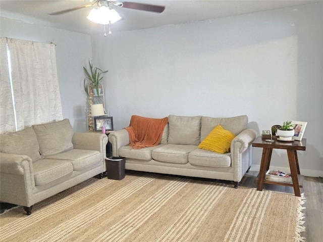 living area with ceiling fan, baseboards, and wood finished floors