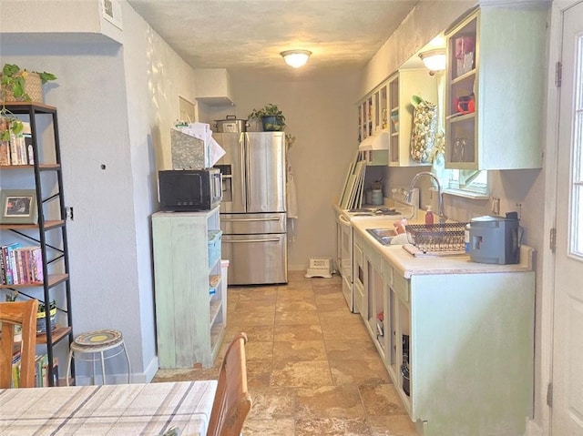 kitchen featuring under cabinet range hood, light countertops, white range with electric stovetop, open shelves, and stainless steel fridge