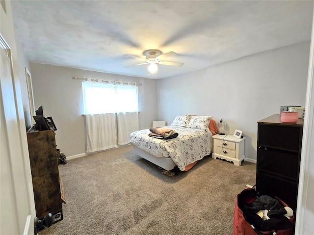 bedroom with a ceiling fan, carpet flooring, and baseboards