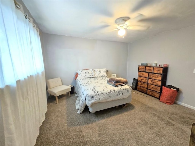 bedroom with carpet, a ceiling fan, and baseboards