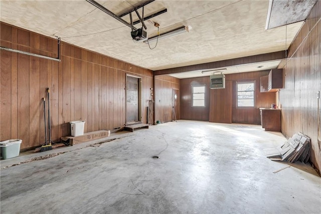 garage featuring wood walls and a garage door opener