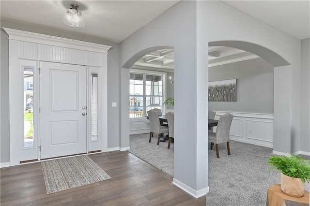 entryway with ornamental molding, coffered ceiling, and dark hardwood / wood-style flooring