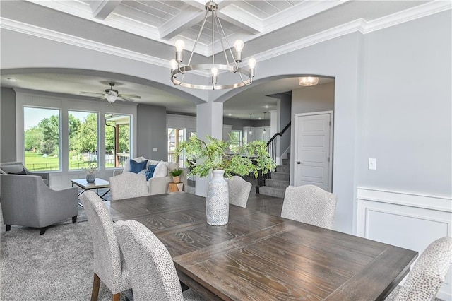 dining space featuring beamed ceiling, crown molding, coffered ceiling, and ceiling fan with notable chandelier