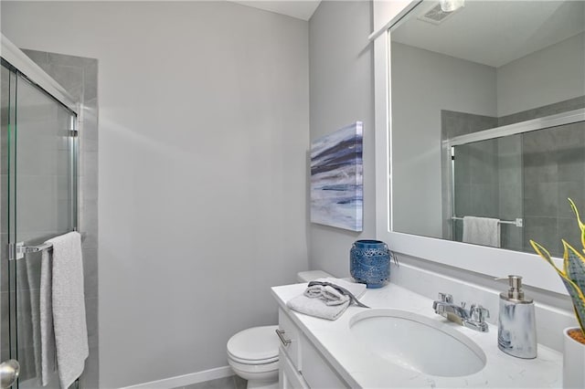 bathroom featuring vanity, toilet, and walk in shower