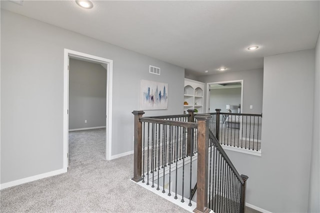 hallway with light carpet