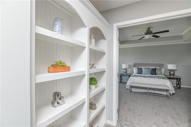 carpeted bedroom featuring ornamental molding and ceiling fan