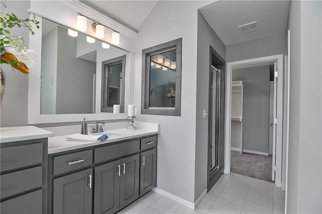 bathroom featuring vanity, vaulted ceiling, an enclosed shower, and tile patterned floors