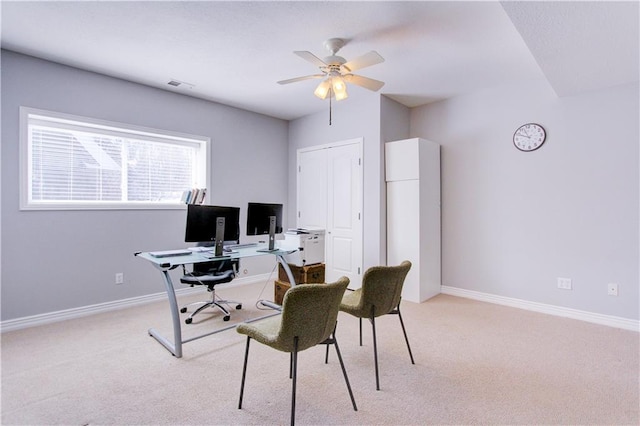 office space with light carpet, visible vents, and baseboards