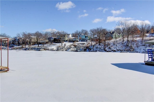 yard layered in snow featuring a residential view