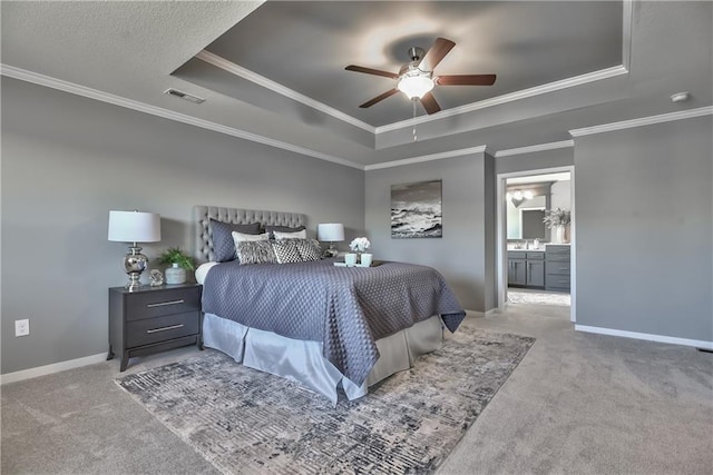 bedroom featuring crown molding, light colored carpet, and a raised ceiling