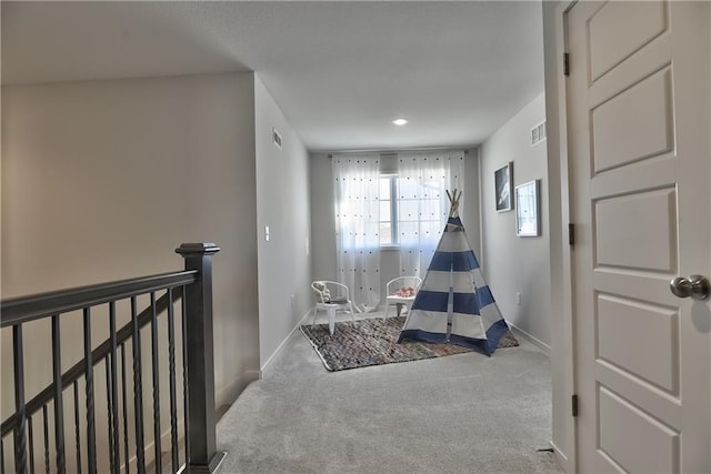 recreation room with carpet flooring