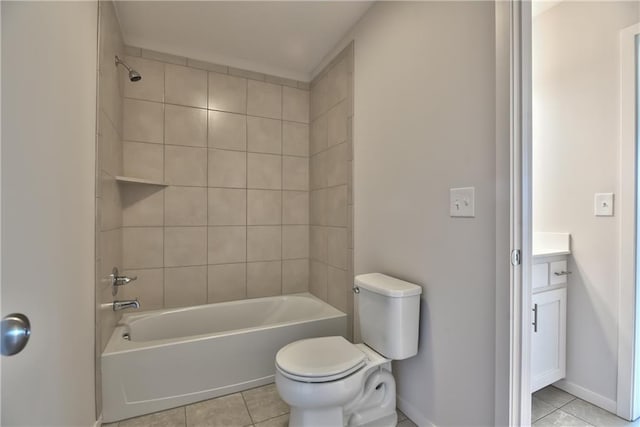 full bathroom with tile patterned floors, vanity, toilet, and tiled shower / bath combo