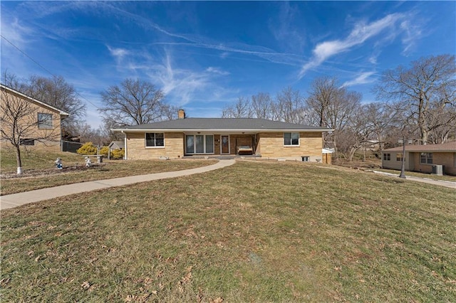 single story home with a front yard and a chimney