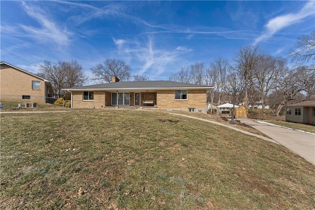 single story home with a chimney and a front lawn