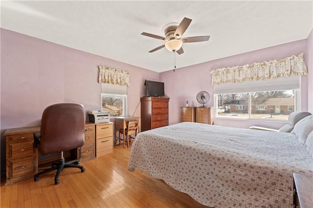 bedroom with a ceiling fan and light wood-style floors