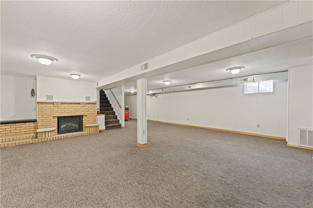 below grade area featuring carpet, a fireplace, and visible vents