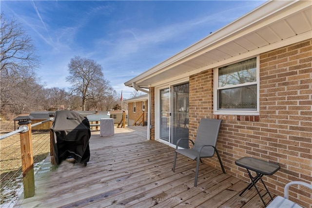 wooden terrace featuring area for grilling