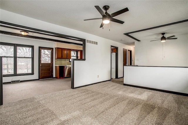 carpeted spare room featuring ceiling fan