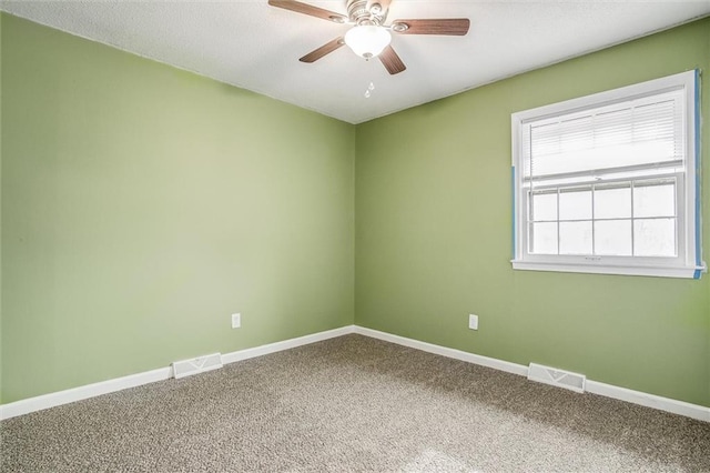 carpeted spare room featuring ceiling fan