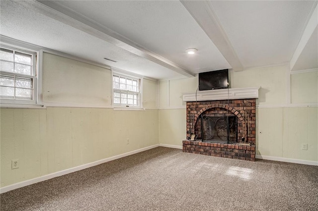 unfurnished living room featuring a brick fireplace, beamed ceiling, and carpet flooring