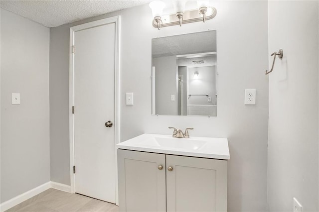 bathroom with vanity and a textured ceiling