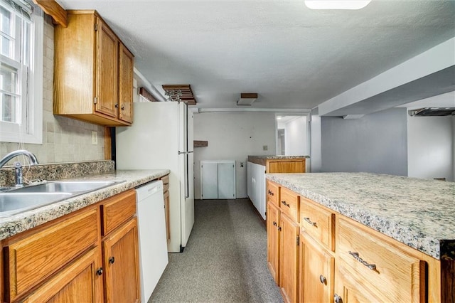 kitchen with a healthy amount of sunlight, sink, decorative backsplash, and dishwasher