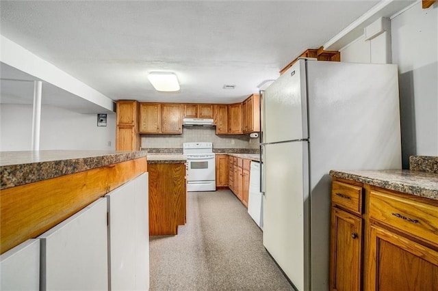 kitchen featuring white appliances and decorative backsplash