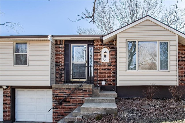 view of front of property with a garage and brick siding