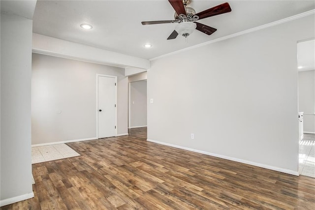 spare room featuring wood finished floors, recessed lighting, crown molding, baseboards, and ceiling fan