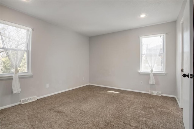 unfurnished room with recessed lighting, visible vents, baseboards, and carpet