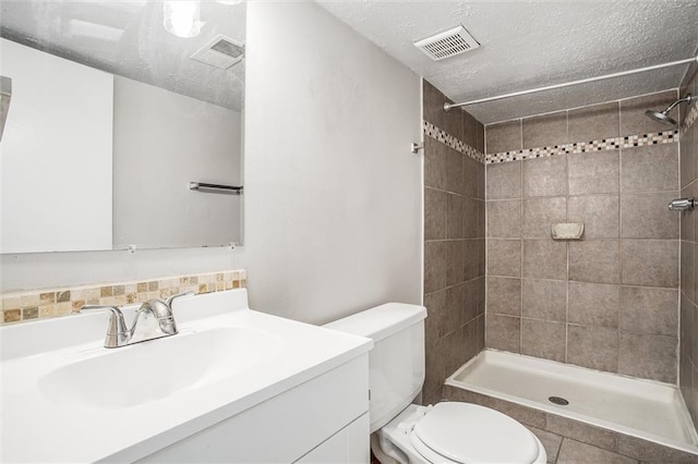 full bathroom featuring visible vents, toilet, and a tile shower