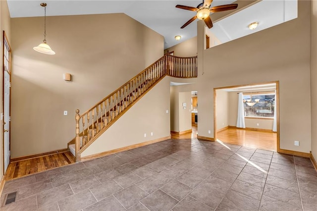 unfurnished living room featuring high vaulted ceiling and ceiling fan