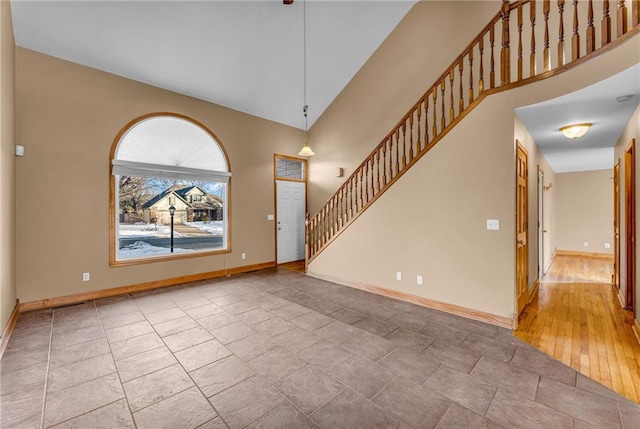 foyer entrance featuring a towering ceiling